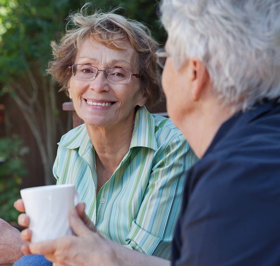 senior woman with glasses smiling at camera