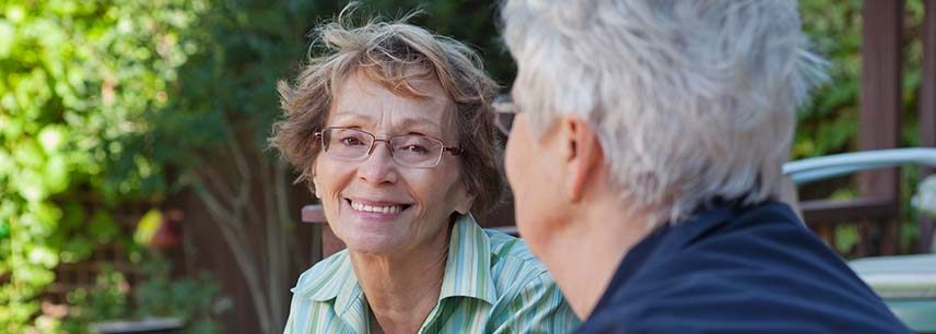 senior woman with glasses smiling at camera
